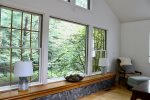 Large windows open to wooded views